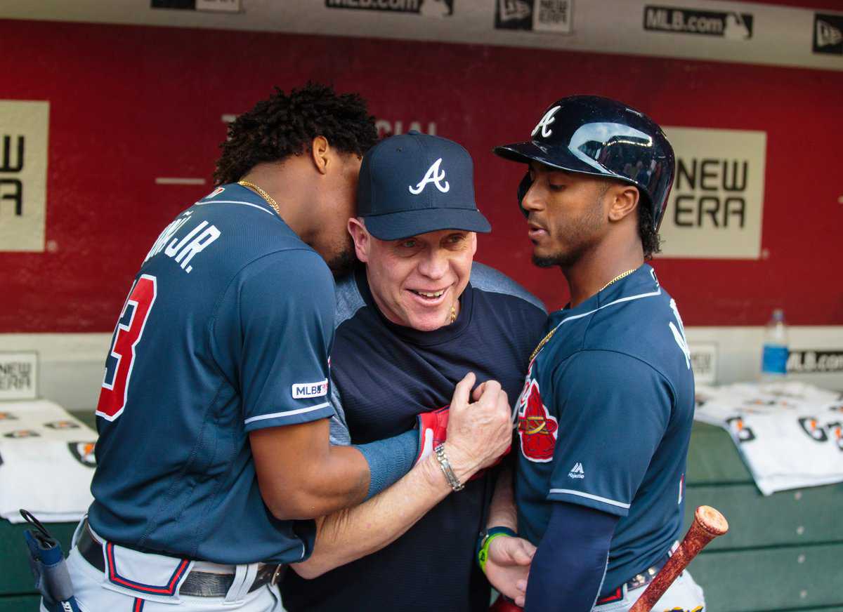 May 9, 2019; Phoenix, AZ, USA; Atlanta Braves outfielder Ronald Acuna Jr. (left) and second baseman Ozzie Albies (right) joke with assistant hitting coach Jose Castro in the dugout against the Arizona Diamondbacks at Chase Field. Mandatory Credit: Mark J. Rebilas-USA TODAY Sports