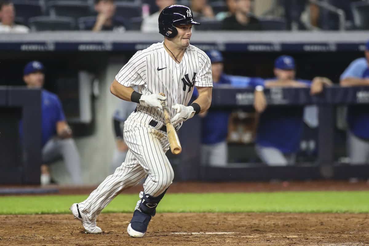 Jul 29, 2022; Bronx, New York, USA; New York Yankees left fielder Andrew Benintendi (18) hits an infield RBI single to tie the game in the eighth inning against the Kansas City Royals at Yankee Stadium. Mandatory Credit: Wendell Cruz-USA TODAY Sports
