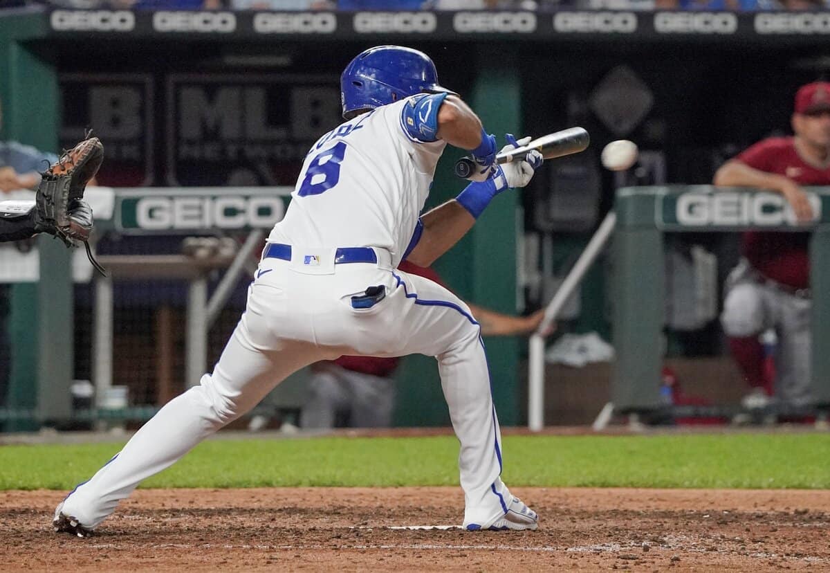 Aug 24, 2022; Kansas City, Missouri, USA; Kansas City Royals shortstop Nicky Lopez (8) lays down a bunt RBI against the Arizona Diamondbacks in the seventh inning at Kauffman Stadium. Mandatory Credit: Denny Medley-USA TODAY Sports