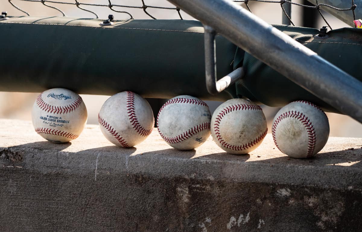 Major-league baseballs in a minor-league dugout