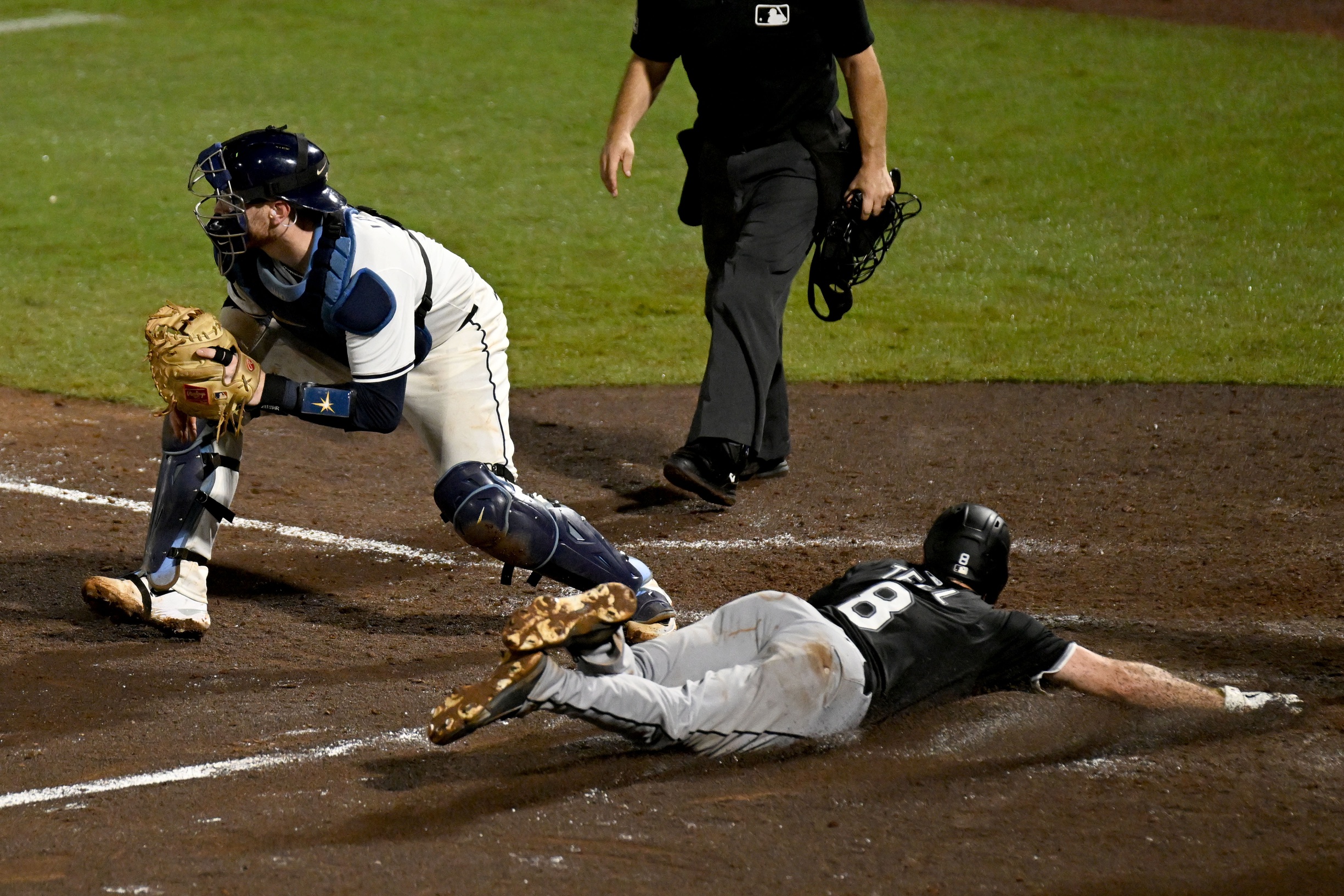 White Sox catcher Kyle Teel slides into home to score a run
