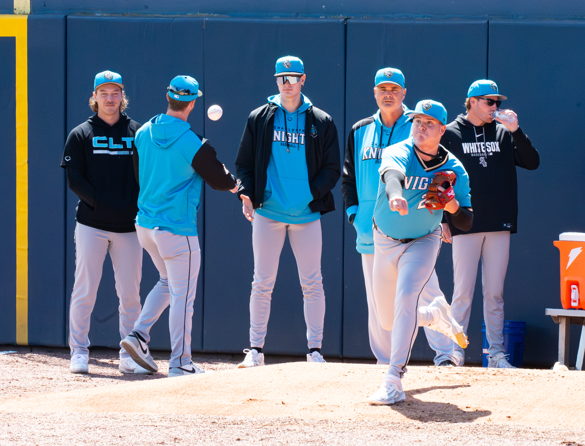 Tanner McDougal warms up while Hagen Smith, Duncan Davitt, Noah Schultz and Jonathan Cannon loom behind Scott Aldred
