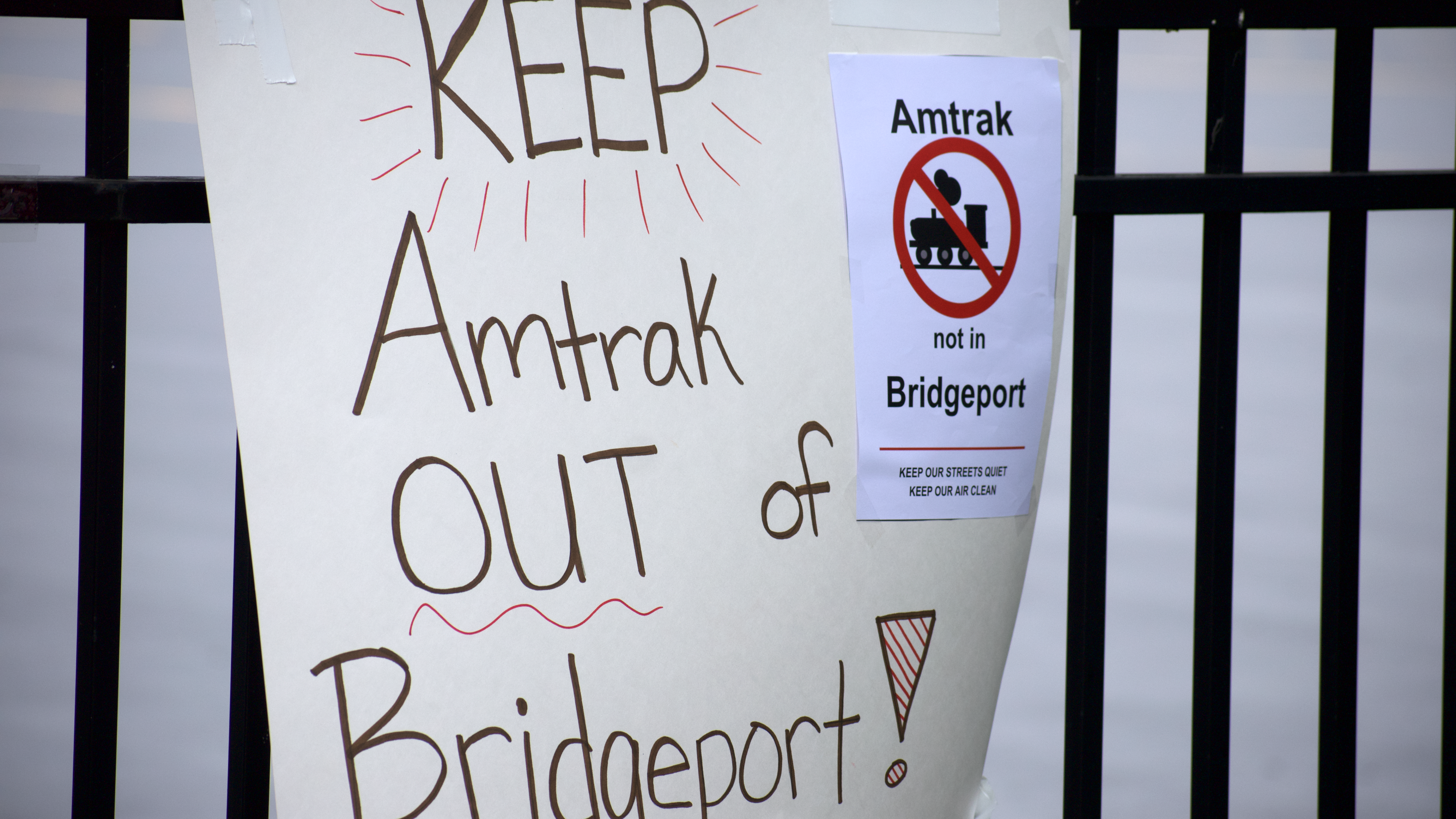 Sign at rally protesting Amtrak's planned maintenance facility in Bridgeport (Photo by Josh Nelson, Sox Machine)