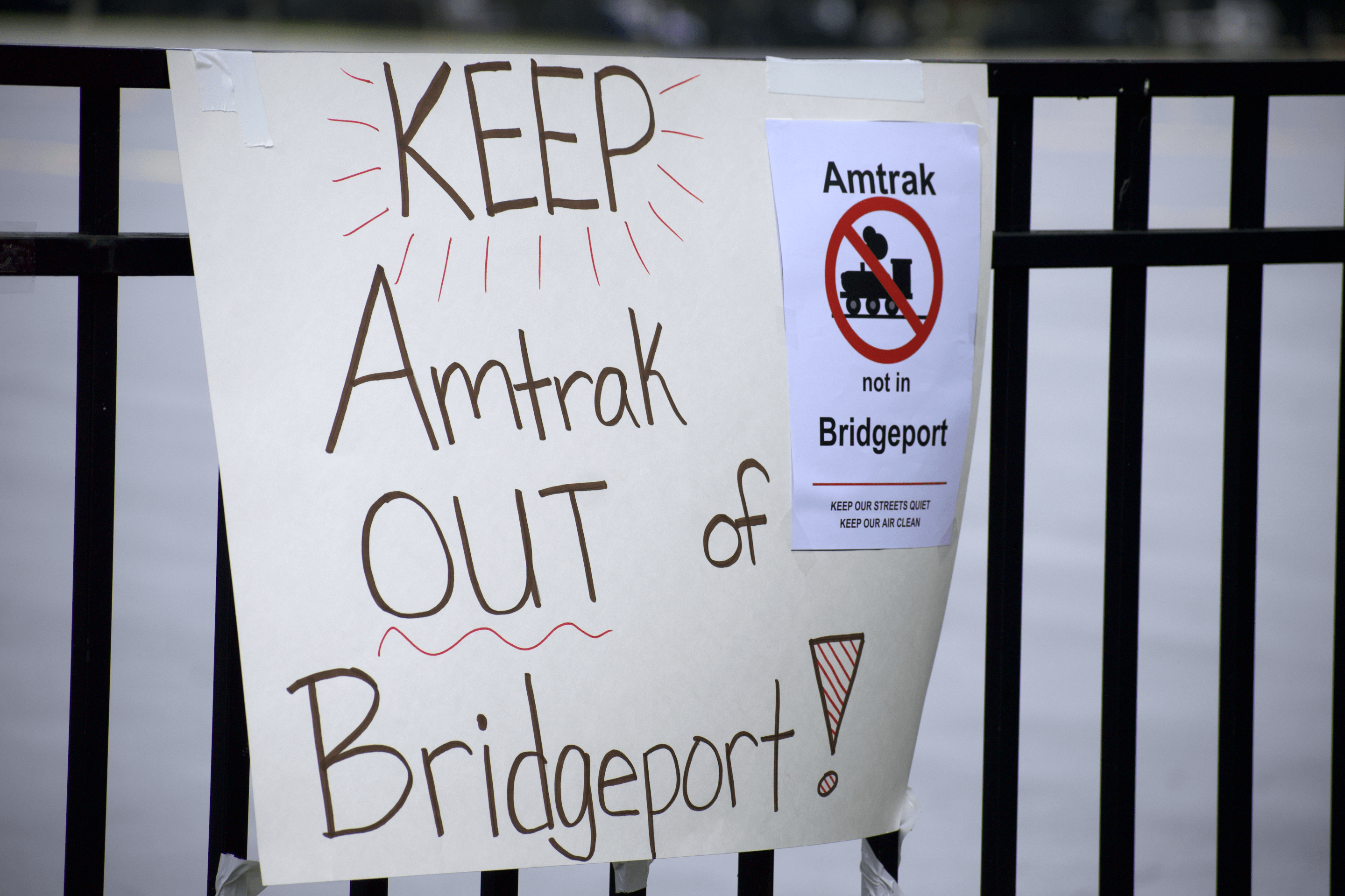 Sign at rally protesting Amtrak's planned maintenance facility in Bridgeport (Photo by Josh Nelson, Sox Machine)