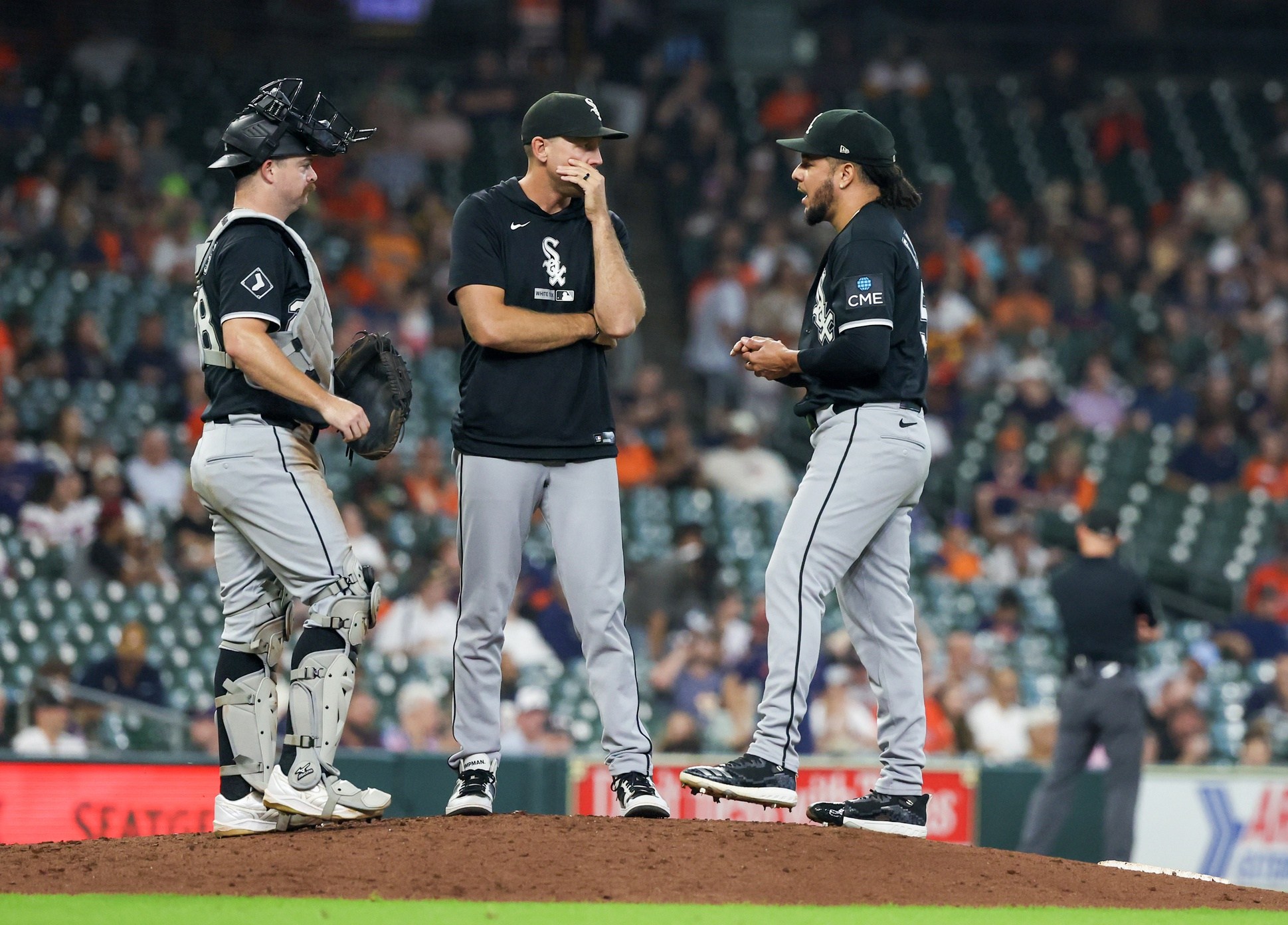 A White Sox mound visit featuring Luis Castillo with Zach Bove and Jake Rogers.